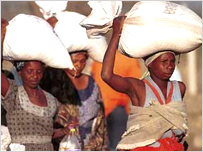 Women carry bags of food